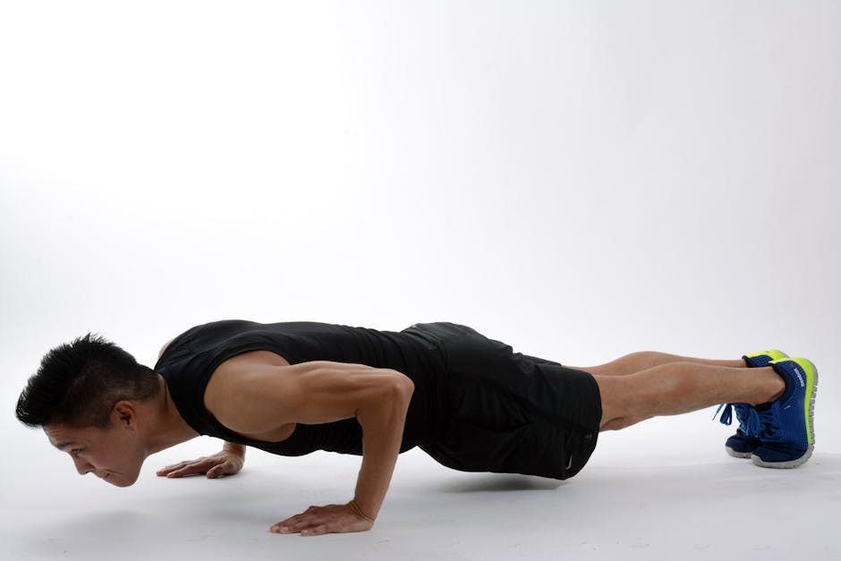 Young man in athletic wear doing push-ups, showcasing strength and fitness
